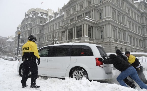 Secret Service officers push a